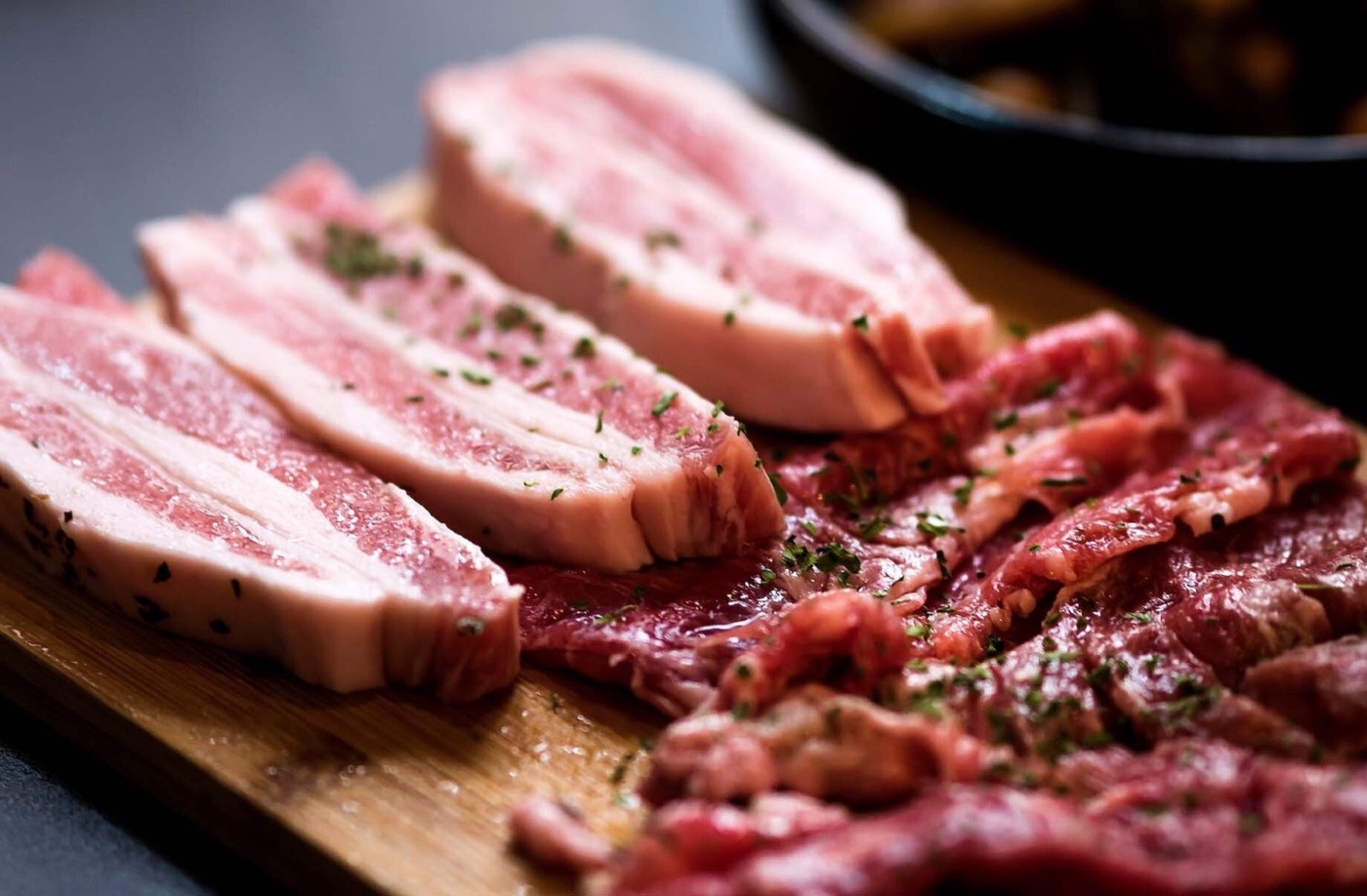 Premium seared pork belly and beef on a wooden board